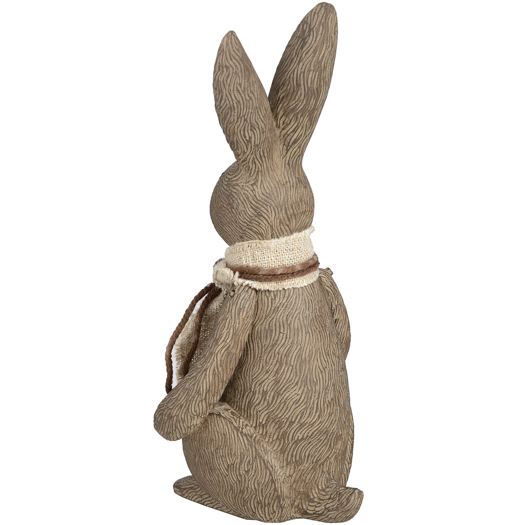 Rear three-quarter view of the rabbit ornament, showing wavy fur-like markings across its back and the scarf wrapped around its neck.