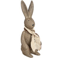 Small brown rabbit ornament viewed from the front at an angle, with long ears and a layered cream and brown scarf.