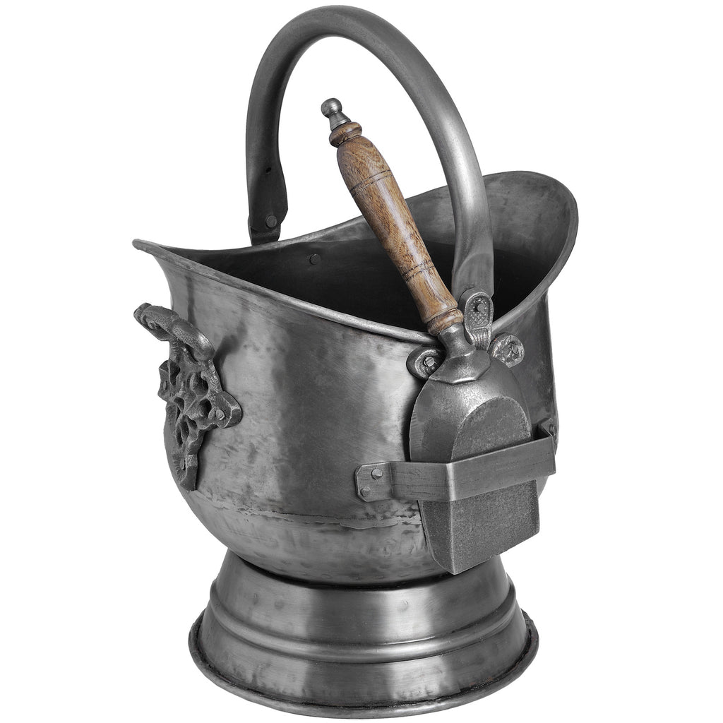 Silver-grey coal bucket with an arched handle, tiered circular base and wooden-handled shovel held in an exterior strap.