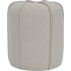 Front view of the round oatmeal footstool, with vertical piping running down its curved upholstered sides.