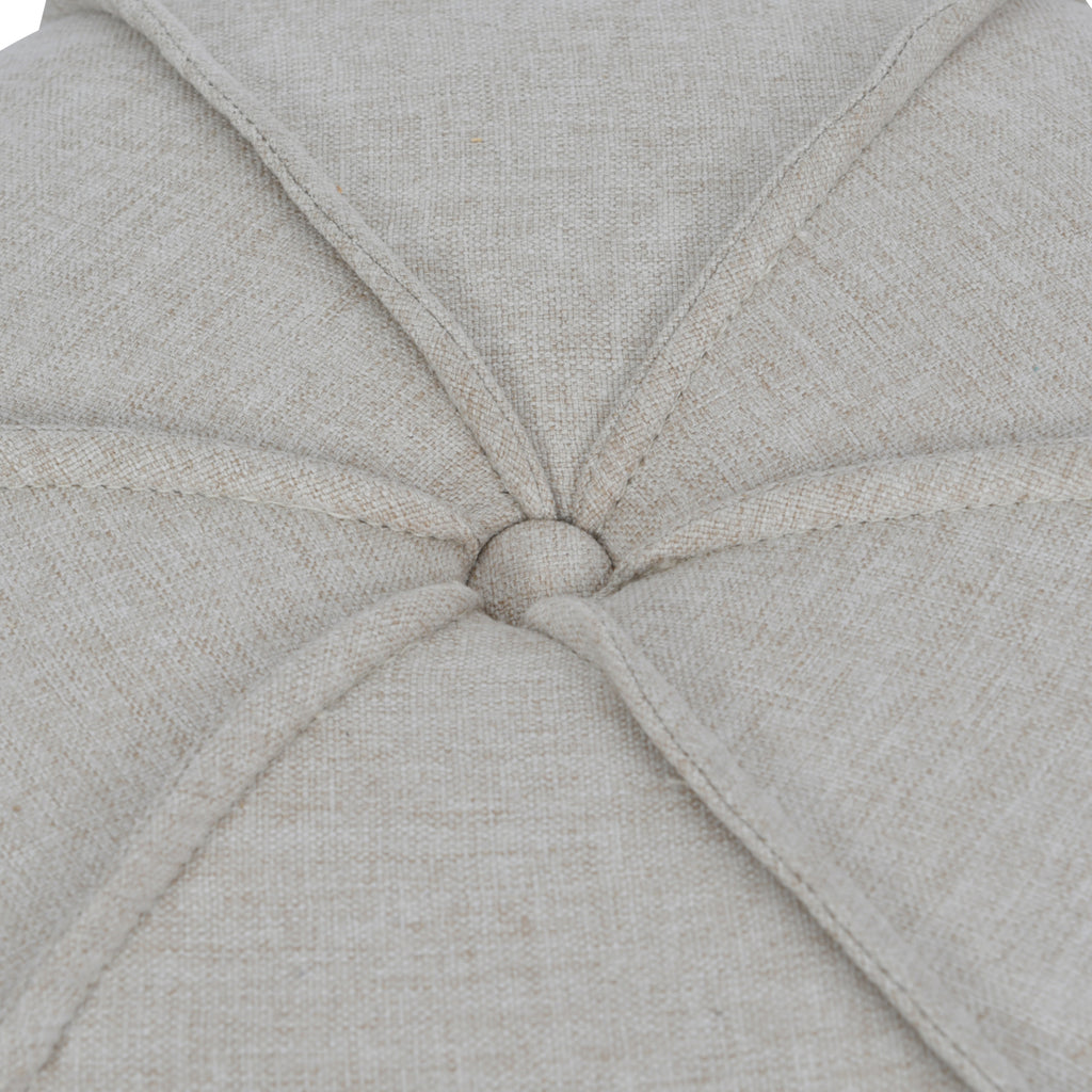 Close-up of the linen-covered top button, surrounded by radiating piped seams and textured oatmeal fabric.
