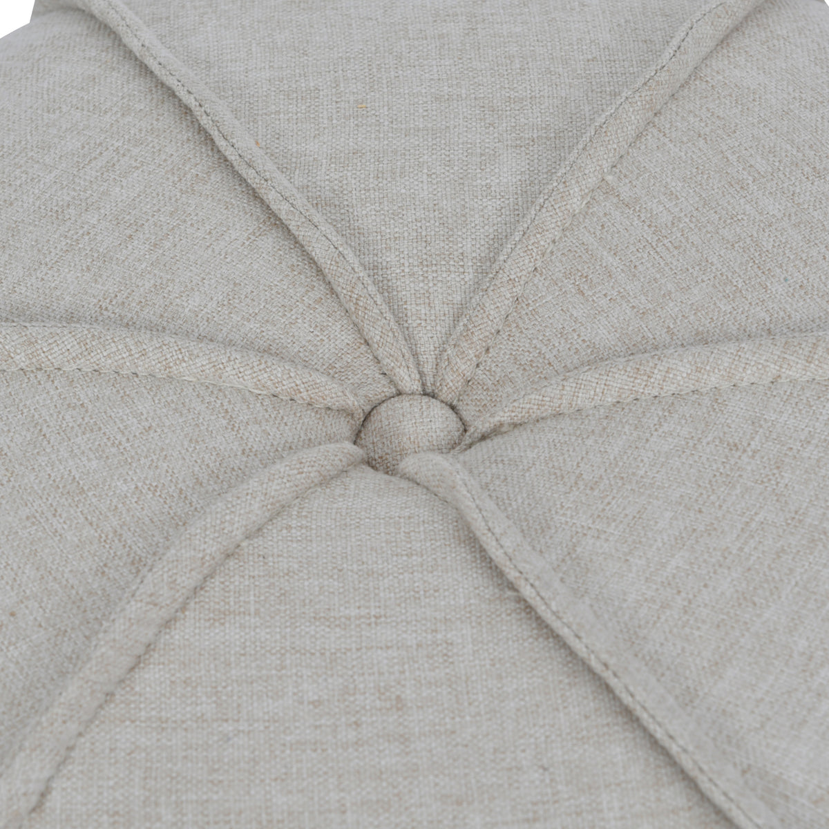 Close-up of the linen-covered top button, surrounded by radiating piped seams and textured oatmeal fabric.