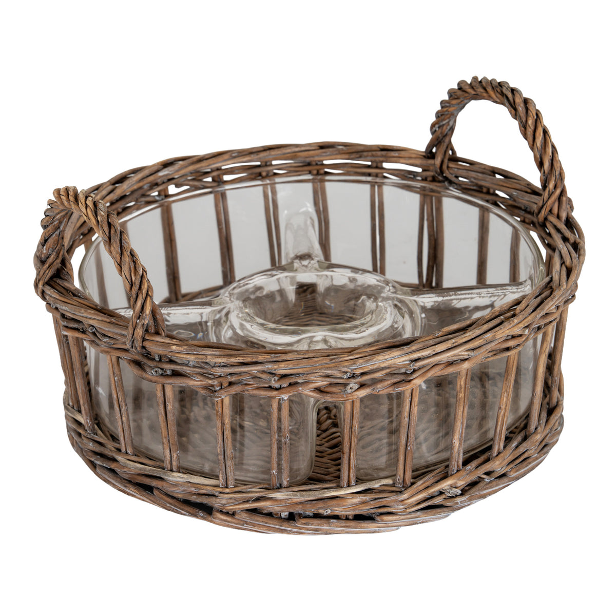 Round brown woven carrier with two arched loop handles, shown at an angle holding an empty transparent dish with a circular centre well and shaped surrounding sections.