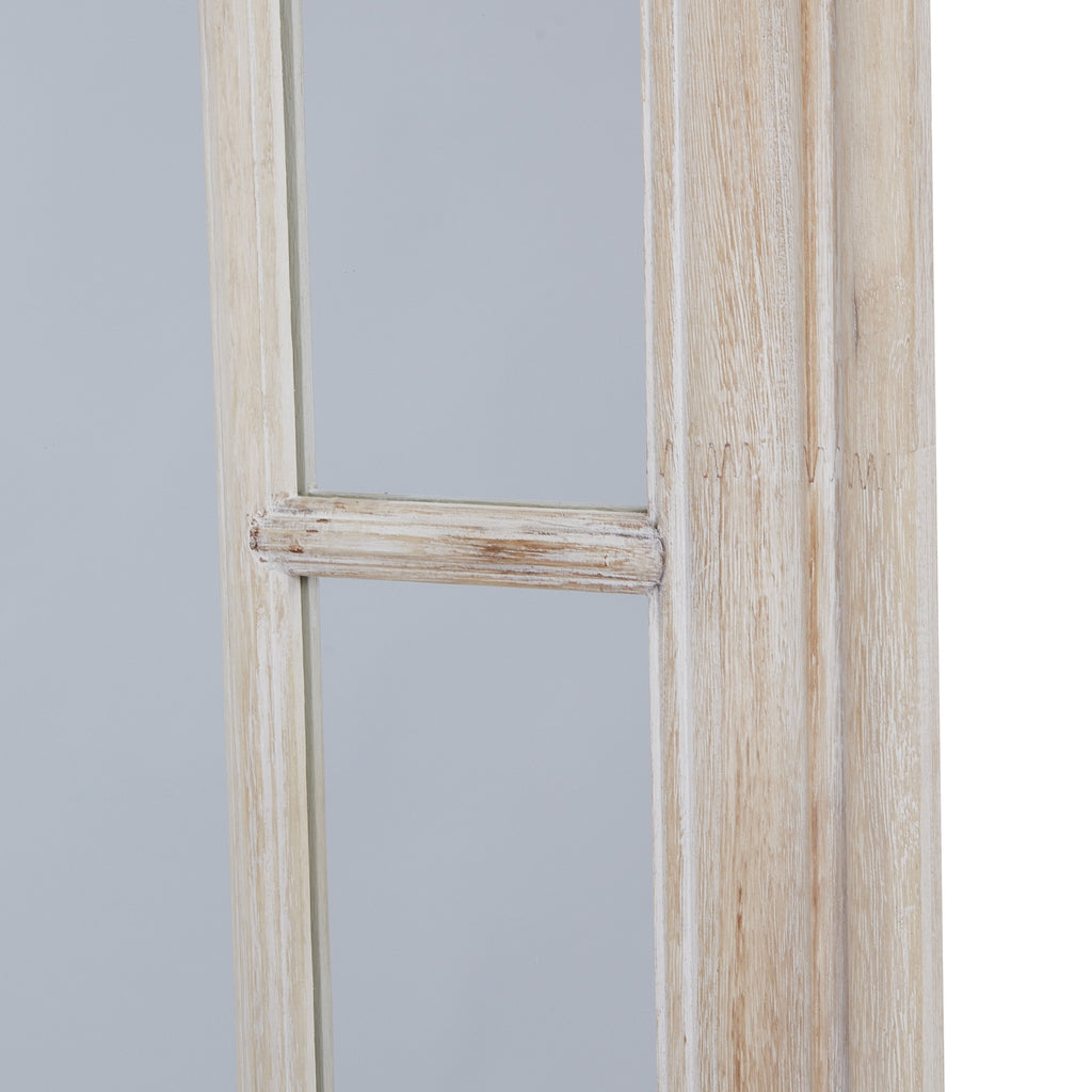 Close-up of a horizontal divider in the mirror's side border, beside the pale frame with warm beige streaks.