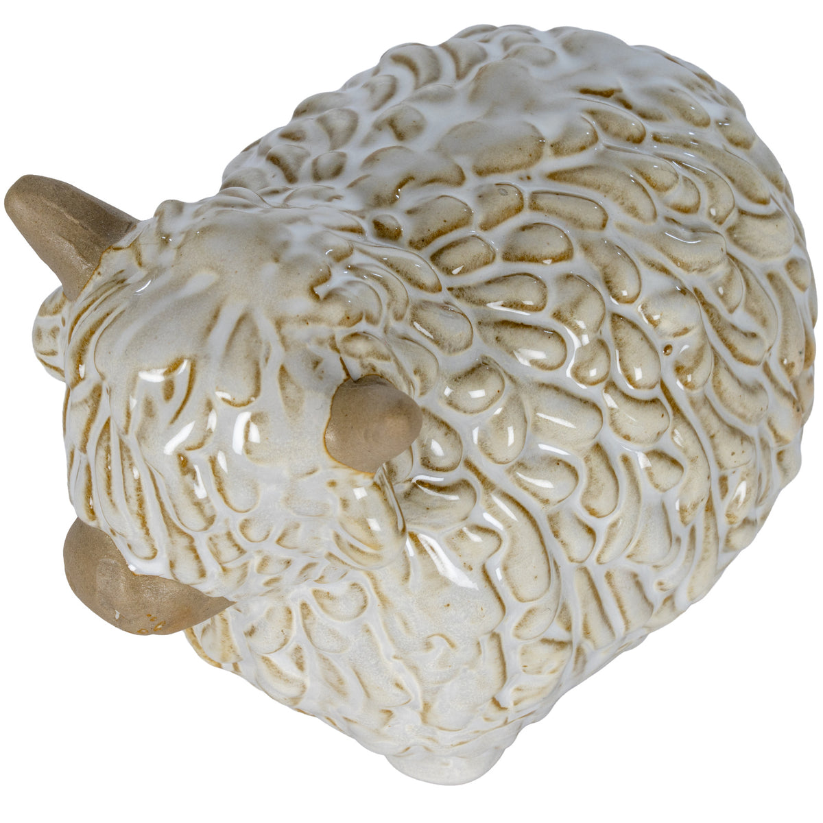 View from above of the Highland cow ornament, showing the long fringe, beige horns and glossy coat texture across its back.
