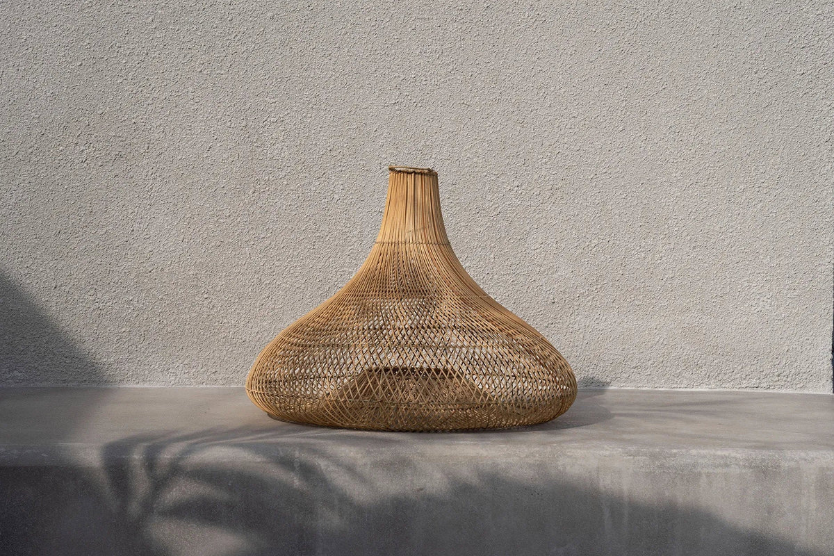 Shala Rattan Pendant Light – Natural, Large – styled against a textured grey wall