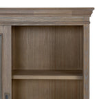 Detail of the shaped crown and upper shelf, with grey-brown grain visible across the frame and interior panels.