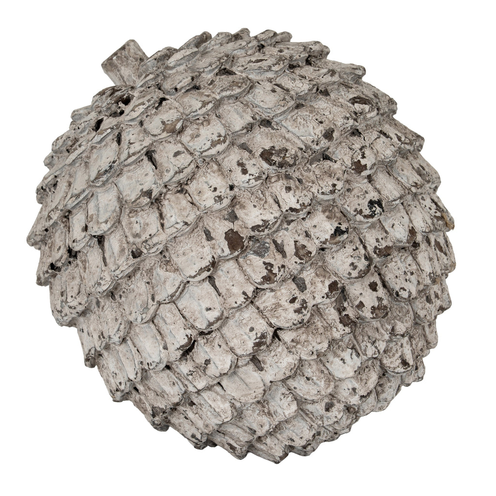 Angled view of the Shingle Orb Decorative Sphere, showing rows of rounded scales and brown patches within the pale distressed finish.