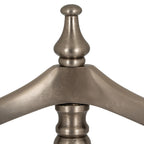 Detail of the rounded finial and sweeping shoulder hanger, showing the valet stand's softly reflective antiqued silver-tone surface.