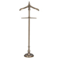 Full front view of an antiqued silver-tone valet stand with a shaped shoulder hanger, tall central post and round stepped base.