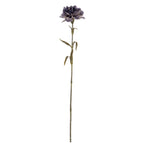 Full view of a purple artificial flower with a ruffled head, long green-brown stem and narrow curved leaves against white.