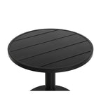 Close-up of the black tabletop showing parallel slats enclosed by a circular rim.