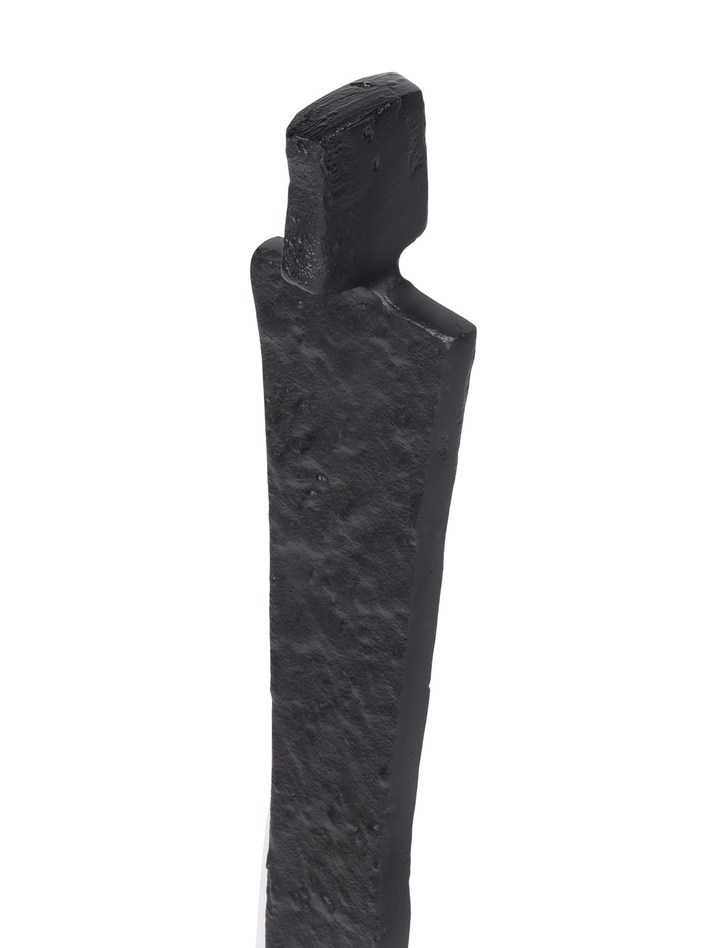 Close-up of the sculpture's rectangular head and shoulders showing the uneven black surface texture.