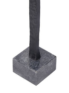 Close-up of the black figure meeting its square grey base with a speckled surface.