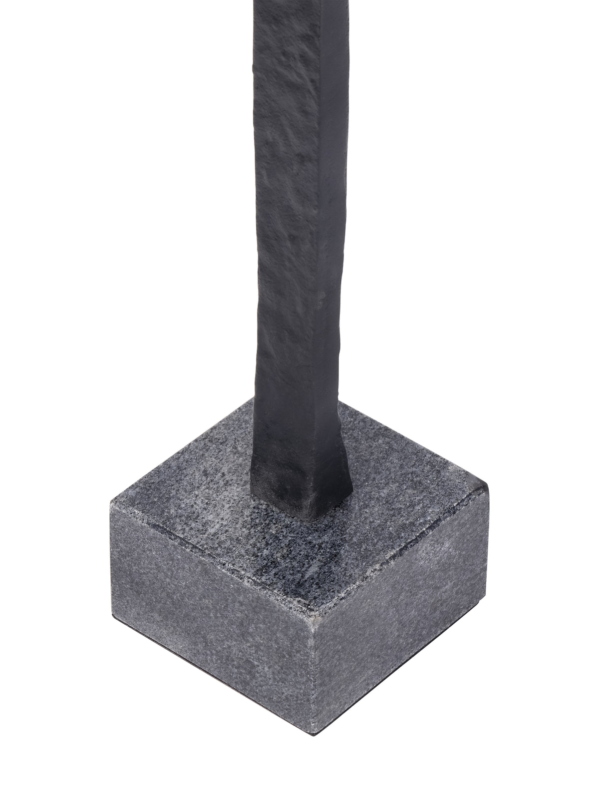 Close-up of the black figure meeting its square grey base with a speckled surface.