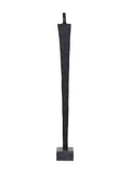 Straight-on view of a tall textured black abstract figure with broad shoulders and a tapering body on a grey block base.