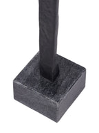 Close-up of the black figure's lower body where it meets the mottled grey square block base.