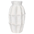 Front view of the slender white vase with softly panelled sides and a gently uneven rim.