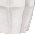 Close-up of the lower panelled body and base, showing the textured white surface and small dark speckles.