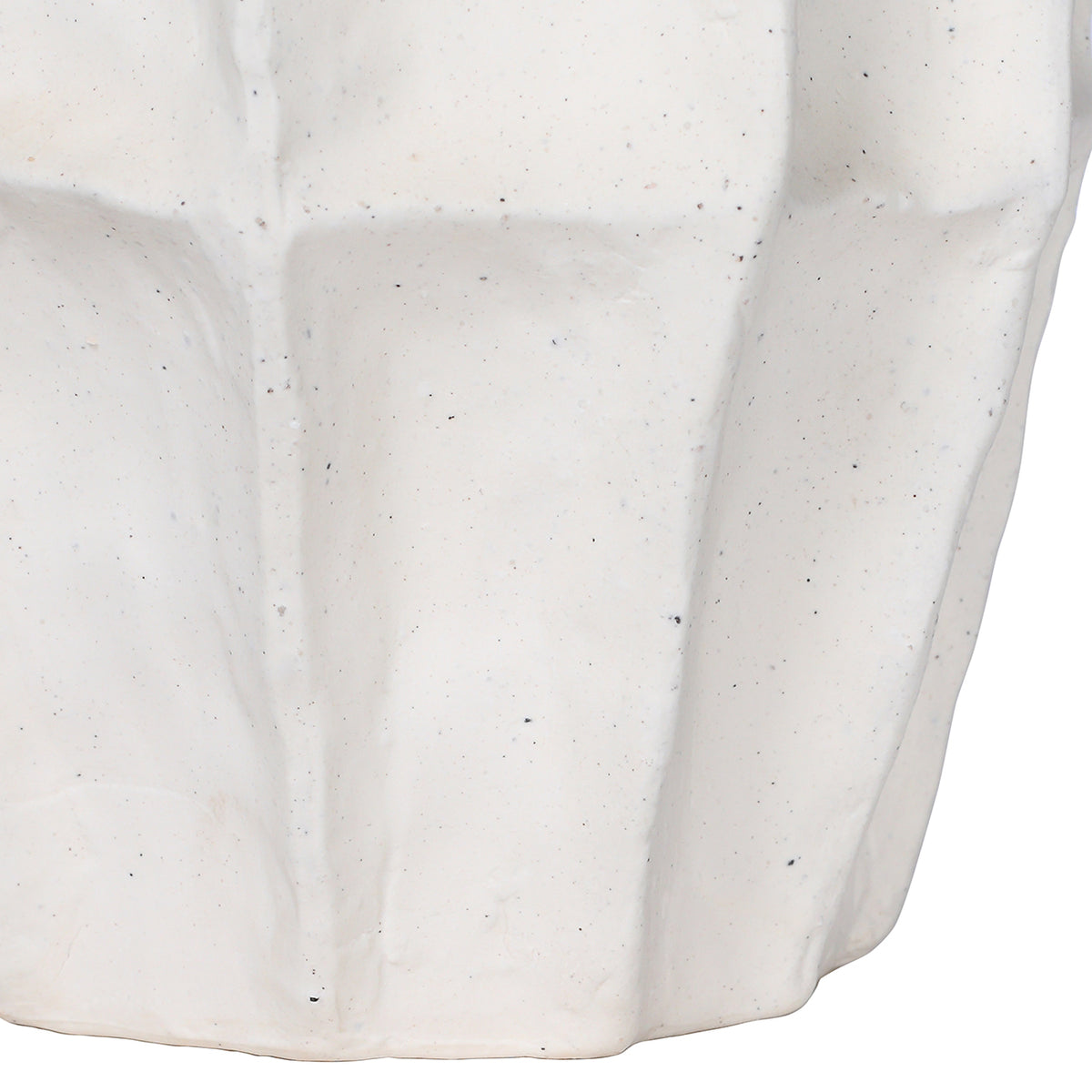 Close-up of the lower panelled body and base, showing the textured white surface and small dark speckles.
