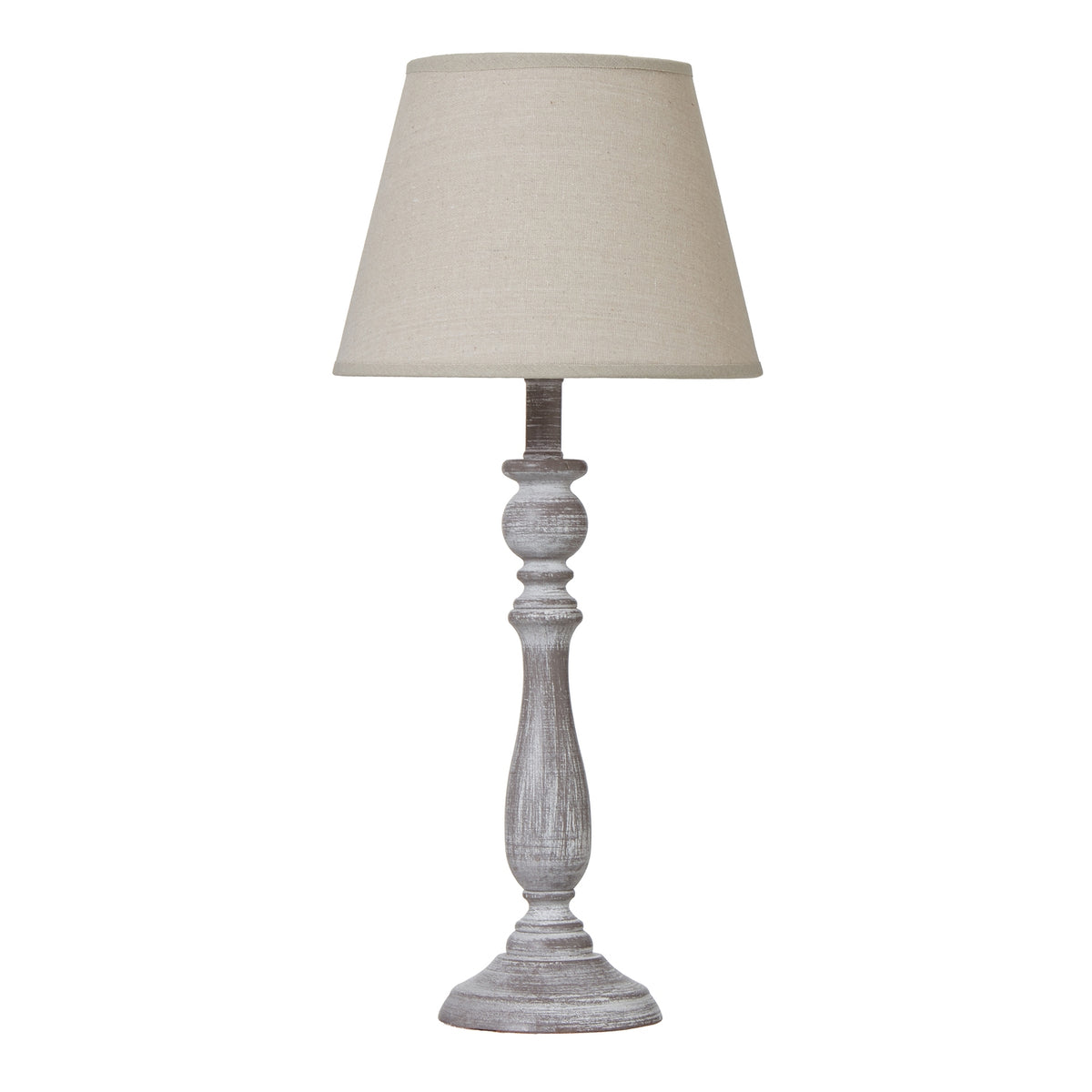 Table lamp with a tapered beige shade, slender whitewashed grey-brown column and round foot against a white background.
