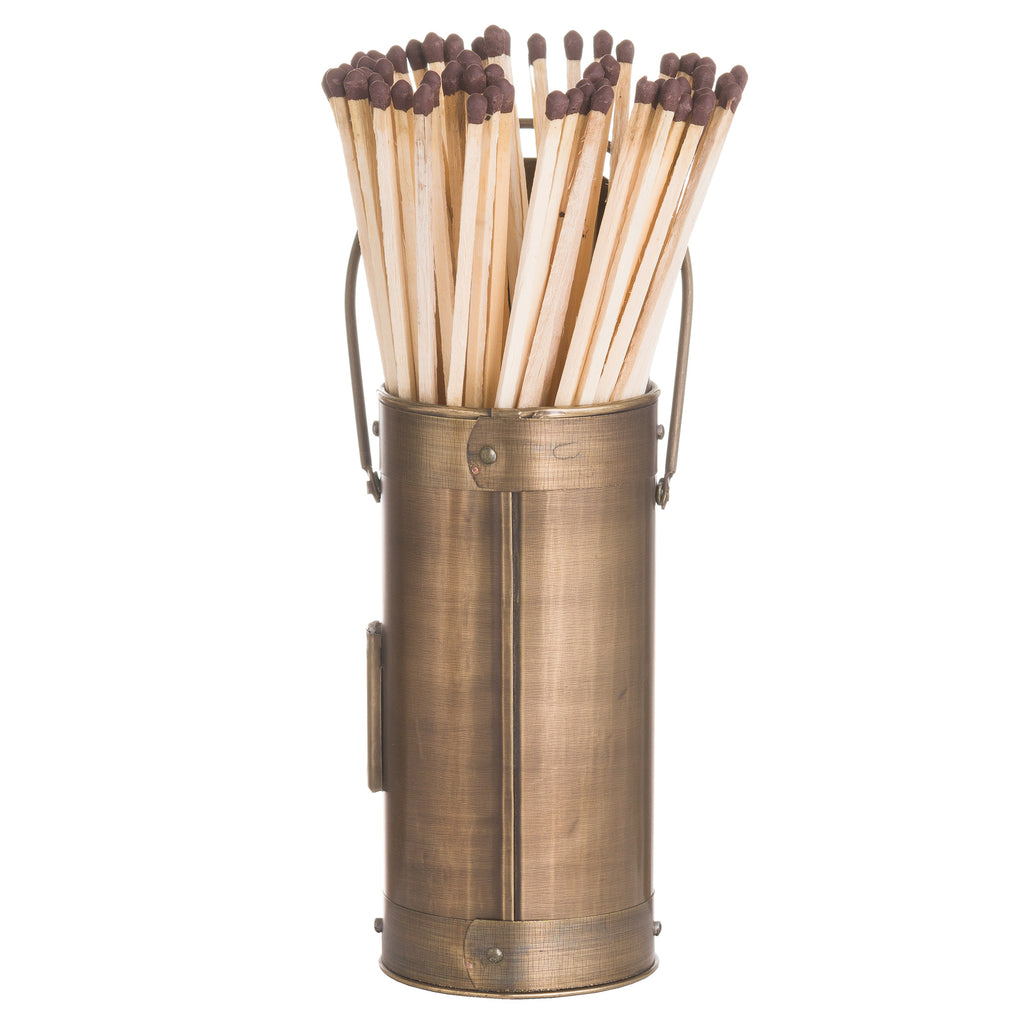 Rear view of a bronze-coloured cylindrical match holder with banded ends, a loop handle and long matches projecting from the top.