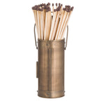 Rear view of a bronze-coloured cylindrical match holder with banded ends, a loop handle and long matches projecting from the top.