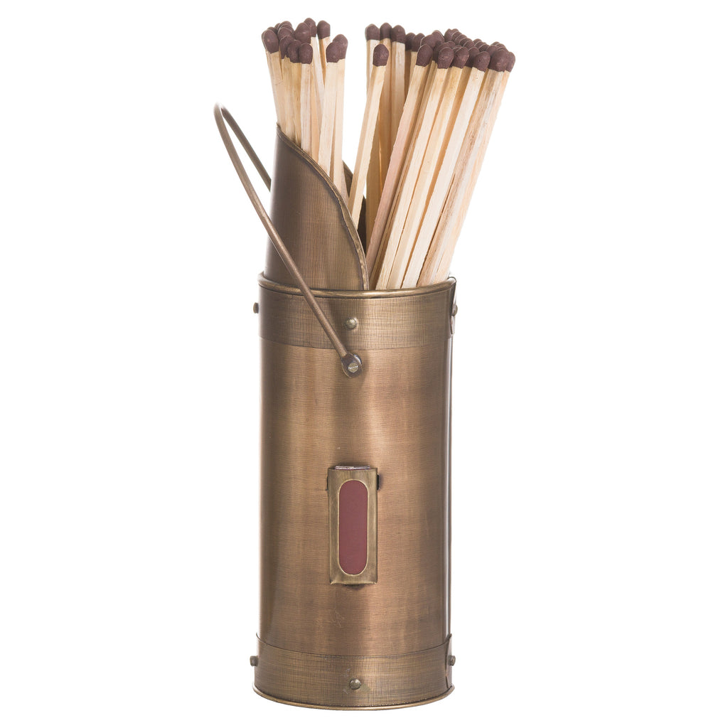 Angled view of the bronze-coloured match holder showing its high sloped rim, loop handle and framed red striking panel, with long matches inside.