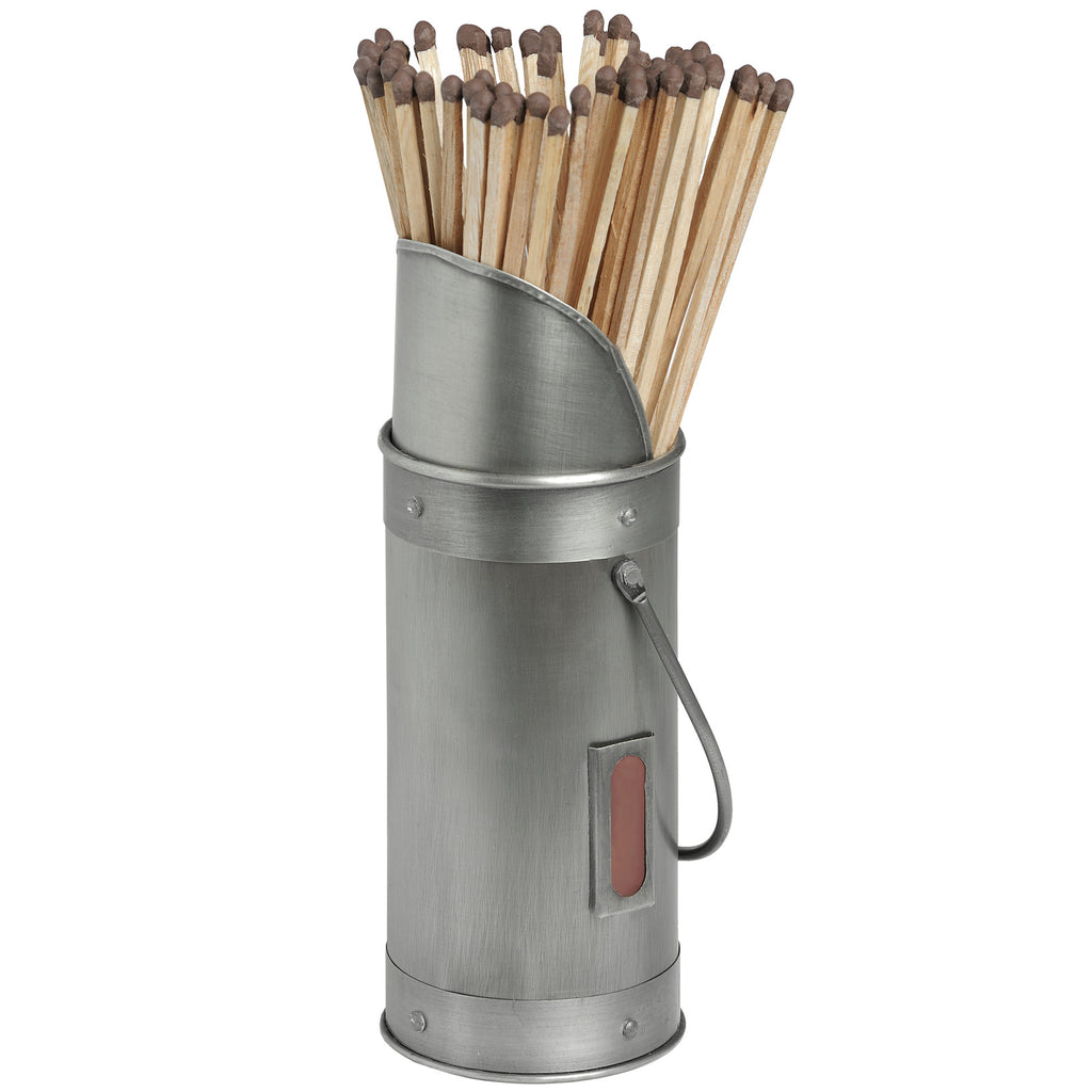 Silver match holder filled with pale wooden matches, showing its sloping rim, riveted bands, loop handle and brown front striker.