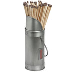 Silver match holder filled with pale wooden matches, showing its sloping rim, riveted bands, loop handle and brown front striker.