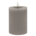 Grey cylindrical LED pillar candle with smooth sides, a recessed top and a white flame insert against a white background.