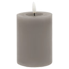 Grey cylindrical LED pillar candle with smooth sides, a recessed top and a white flame insert against a white background.