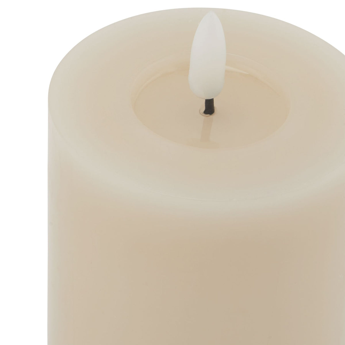 Close-up from above showing the candle's shallow circular recess and white flame-shaped insert on a short dark stem.