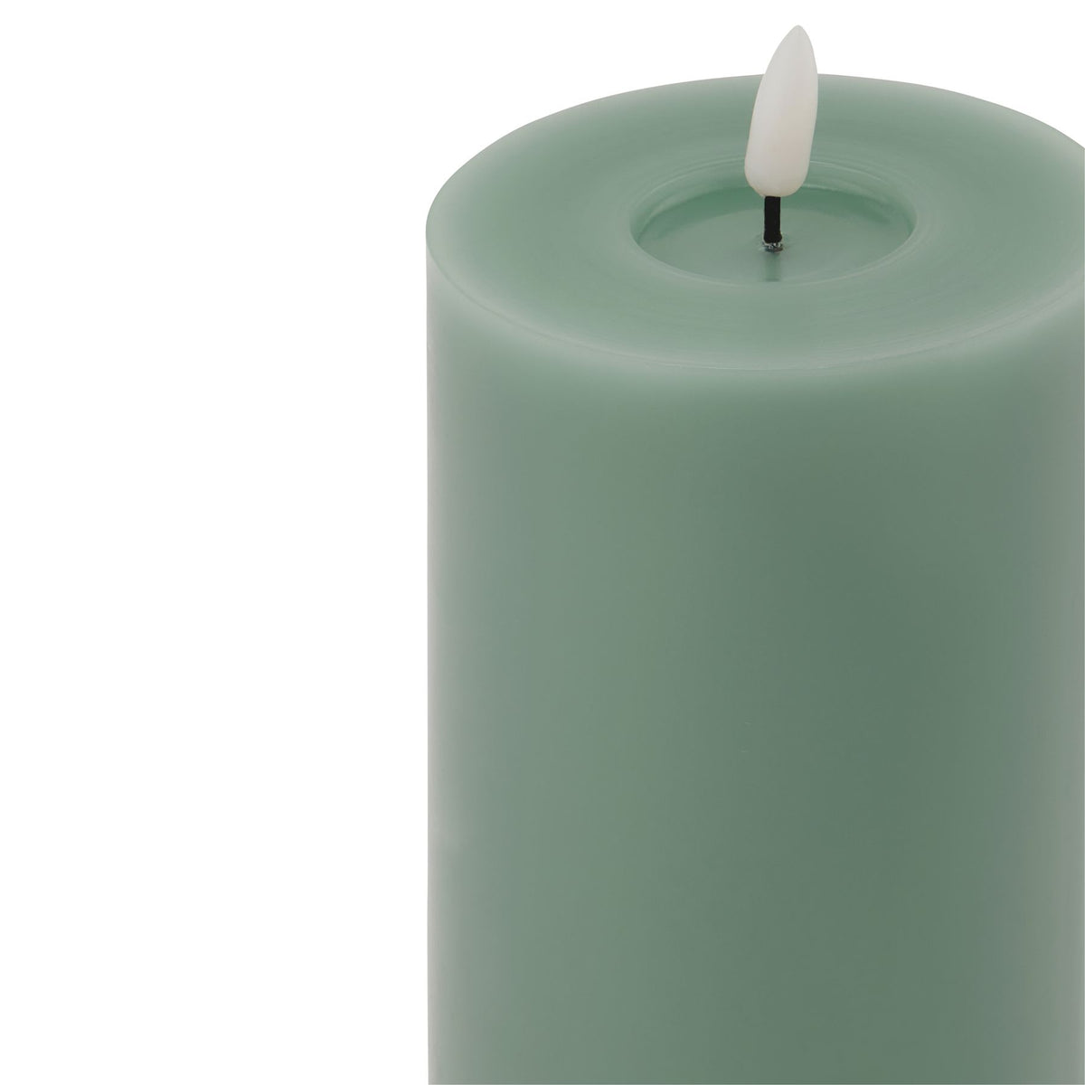 Close-up of the candle's rounded green upper edge and shallow circular recess around a pale flame-shaped element on a dark stem.