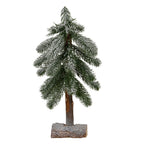 Full view of a narrow snow-effect decorative tree with drooping green branches, an exposed brown trunk and a white-dusted half-log-style base.