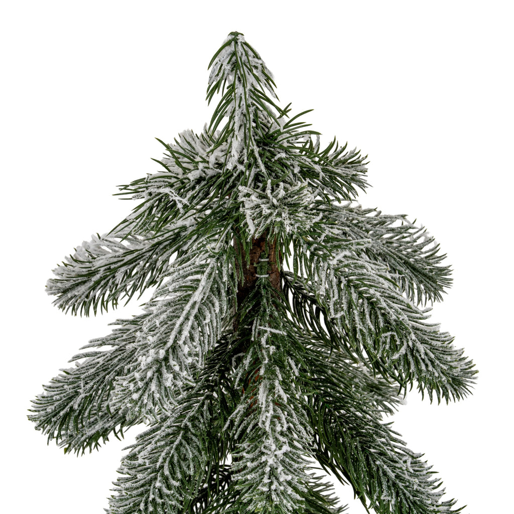 Close-up of the decorative tree's pointed top and tiered green needles with uneven white flocking, showing the brown trunk between the branches.