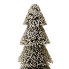 Close-up of the tree's upper tiers, showing uneven off-white flocking over dark olive-brown bristles and the spaces between each tier.
