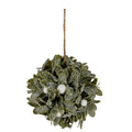 Snowy artificial foliage ball with olive-green leaves and ivory-white berries beneath a long brown hanging cord, shown against white.