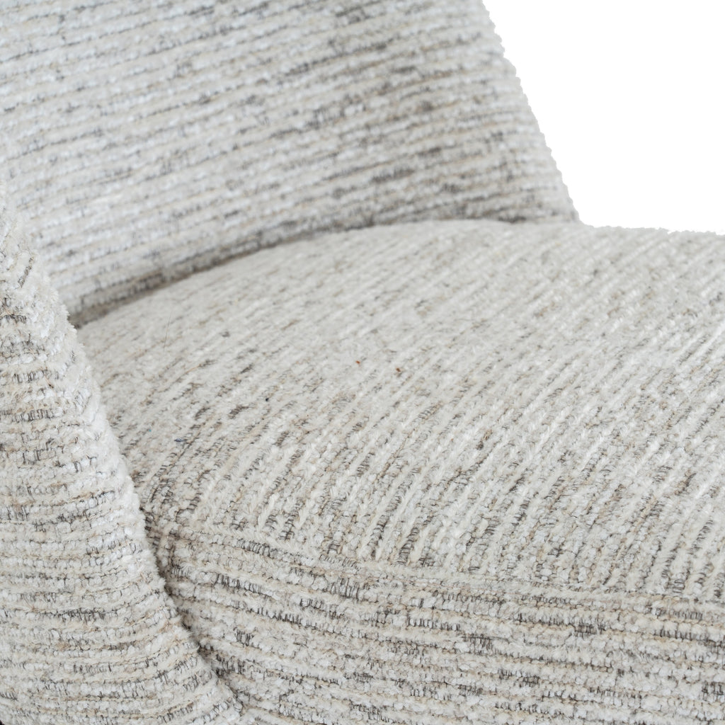 Close-up of the chair's rounded seat and back, showing pale raised texture with fine grey and beige lines.