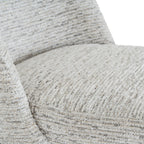 Close-up of the chair's rounded seat and back, showing pale raised texture with fine grey and beige lines.