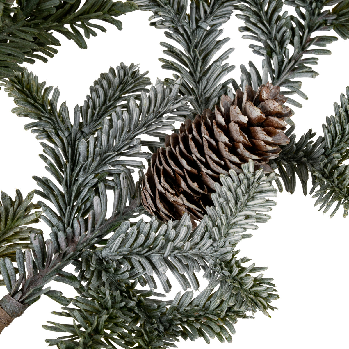 Close-up of a brown pinecone nestled among dark and grey-green needle-like foliage on the artificial spray.