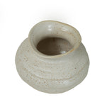 View from above showing the vase's irregular oval opening, speckled interior and rounded shoulders.