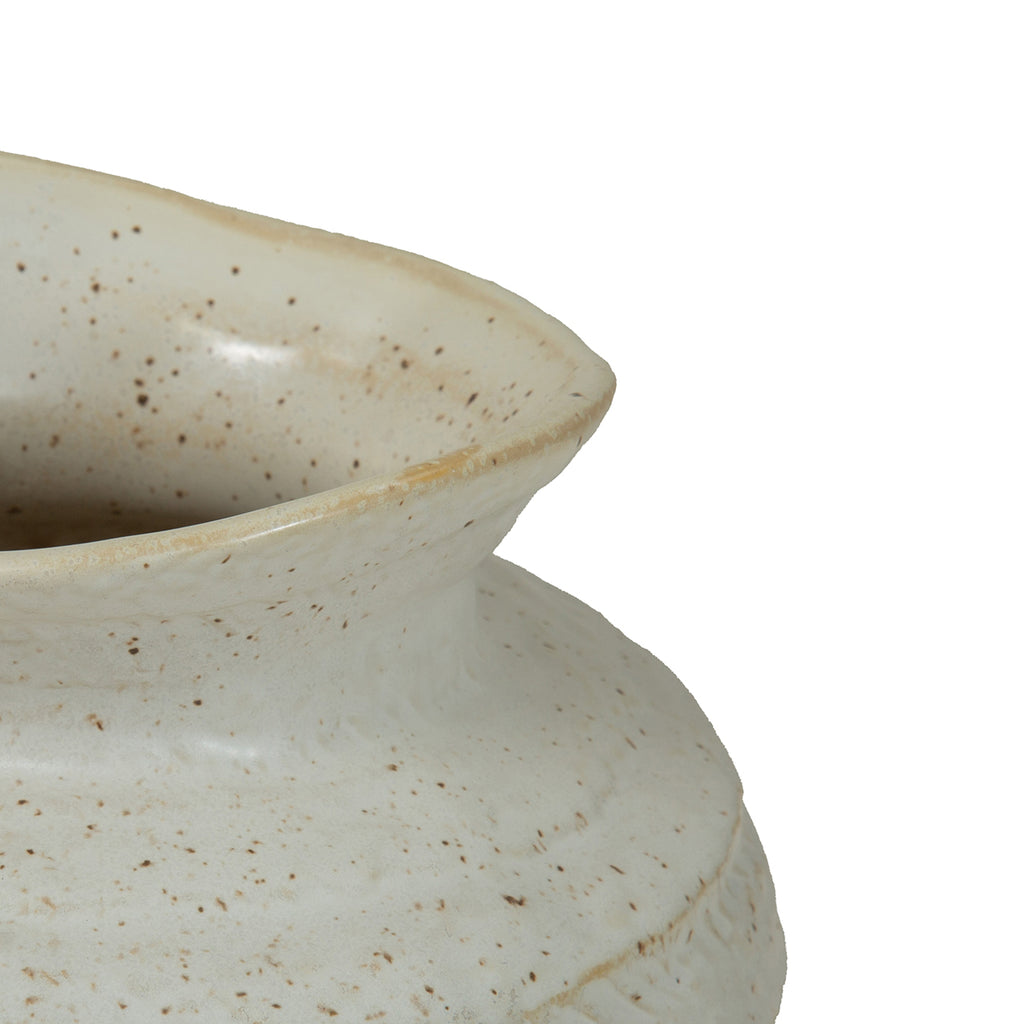 Close-up of the vase's curved, uneven rim and neck, with natural-toned speckles across the ivory glaze.