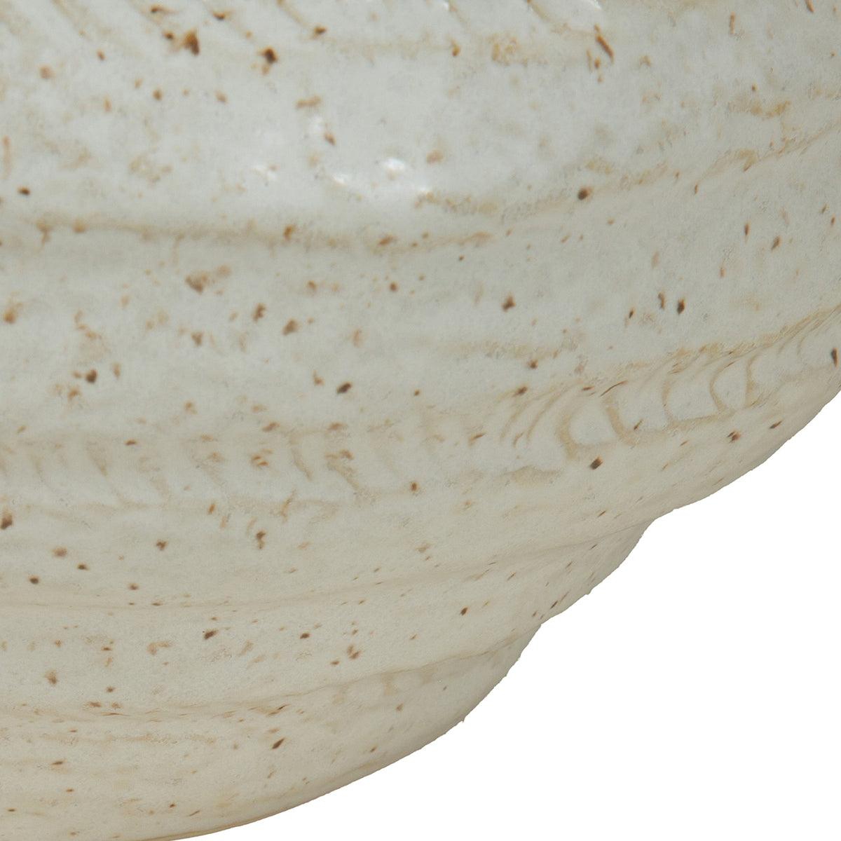 Close-up of the vase body showing shallow textured markings, irregular horizontal bands and brown speckles in the ivory glaze.