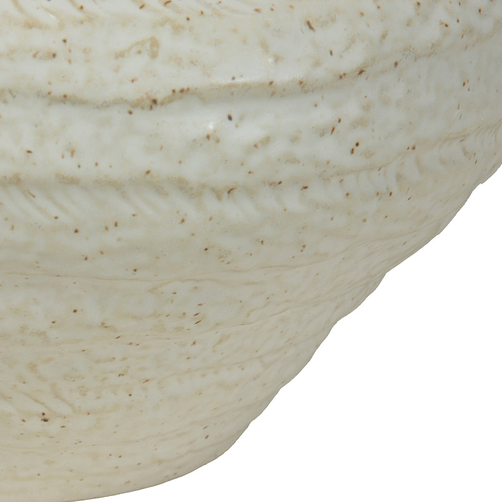 Close-up of the vase body showing irregular horizontal ridges, textured markings and darker speckles in the ivory glaze.