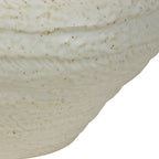 Close-up of the vase body showing irregular horizontal ridges, textured markings and darker speckles in the ivory glaze.