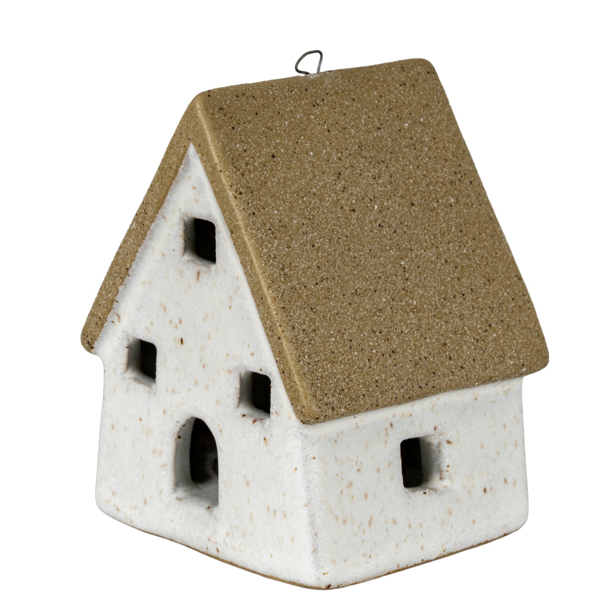 Three-quarter view of a cottage decoration with a steep speckled tan roof, off-white walls, square window openings and an arched doorway.