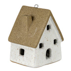 Opposite three-quarter view of the speckled cottage decoration, showing the small roof chimney, dark ridge loop and open windows.