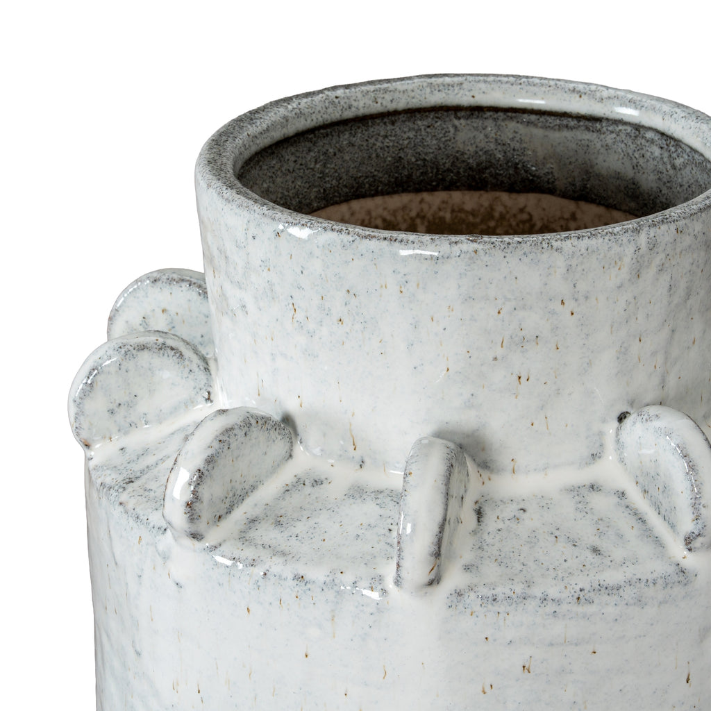 Angled close-up into the vase's open neck, showing the dark speckled interior, glossy rim and upright shoulder fins.