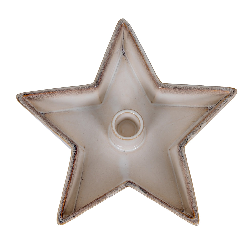 Overhead view of an empty warm off-white star candle holder with five upturned points, speckled edges and a central round socket.